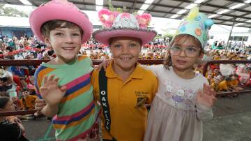  Oak Flats Public Preschool students Patrick Thomson and Zahra Butt with Oak Flats Public School year 5 student Addilyn-Lee Rae during the Easter Hat Parade. Picture by Robert Peet