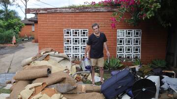 Bellambi's Brett Marraige with flood damaged household items. Picture April 7 by Sylcia Liber.